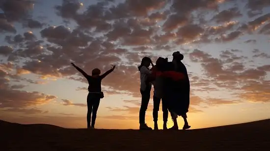 A family on the dunes at sunset