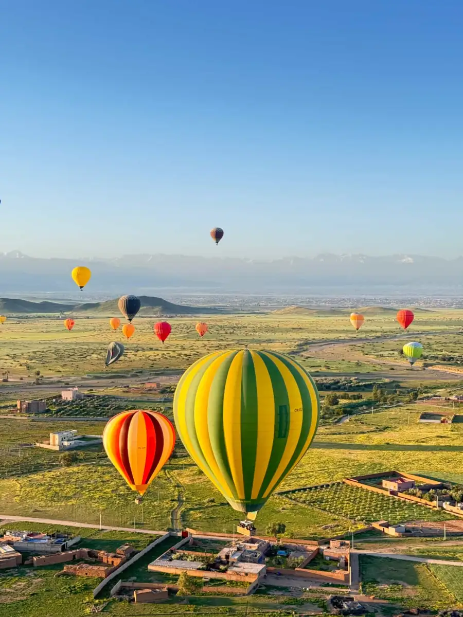 Hot-air balloons at sunrise over the countryside near Marrakech